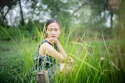 Portrait of young woman on field