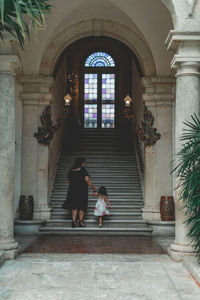 Rear view of man sitting on staircase