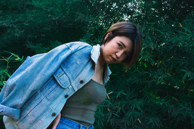 Portrait of young woman on field