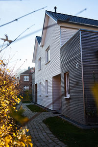 Street amidst houses and buildings against sky