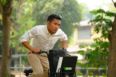 Side view of young man using mobile phone