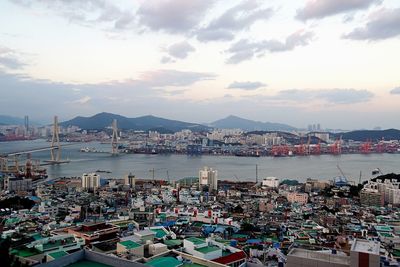 Boats in river with cityscape in background