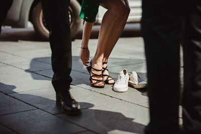 Low section of people standing on footpath