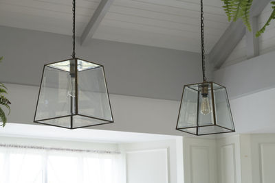 Low angle view of illuminated pendant lights hanging from ceiling