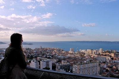 Rear view of woman looking at cityscape 