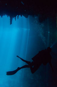 Young man scuba diving undersea