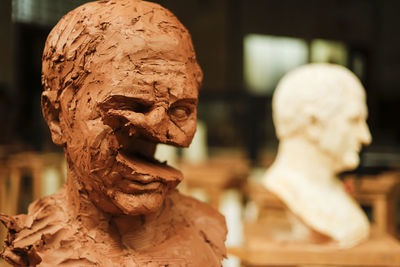 Destructed clay head in art studio