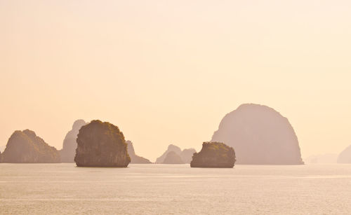 Rocks in sea against sky