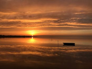 Scenic view of sea against orange sky