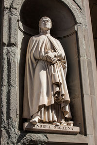 Statue of andrea orgagna at the courtyard of the uffizi gallery in florence