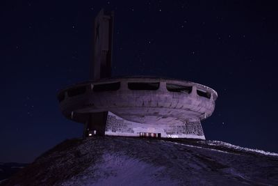 Low angle view of built structure against sky at night