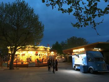 People on illuminated street at night