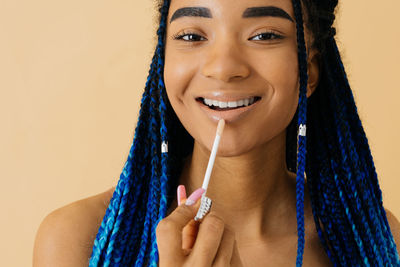 Portrait of smiling young woman with eyes closed