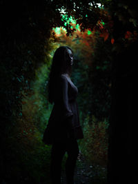 Rear view of woman walking in forest