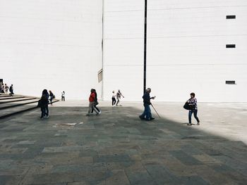 People walking in front of built structure