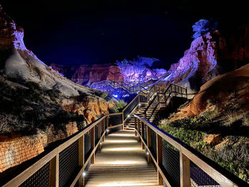 Illuminated footbridge at night