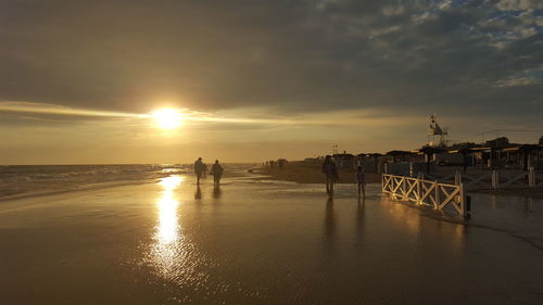 Scenic view of beach against sky during sunset