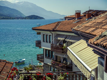 High angle view of buildings by sea against sky