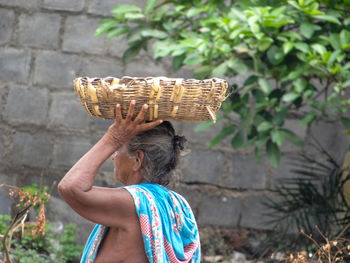 Side view of senior woman carrying basket