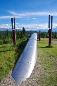 Pipe on grass against sky