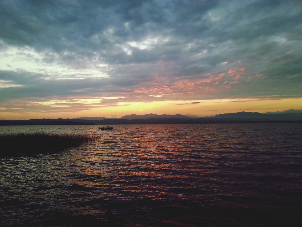 sunset, water, tranquil scene, scenics, sky, tranquility, beauty in nature, cloud - sky, waterfront, nature, idyllic, orange color, rippled, cloud, sea, dramatic sky, lake, cloudy, reflection, silhouette