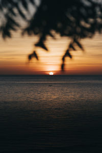 Scenic view of sea against orange sky