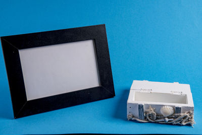 High angle view of laptop on table against blue background