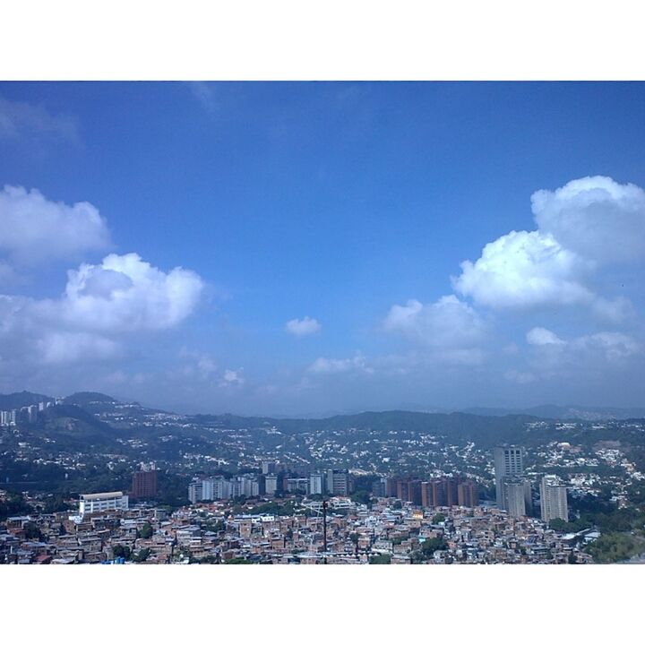 cityscape, city, transfer print, building exterior, architecture, sky, crowded, built structure, auto post production filter, cloud - sky, residential district, high angle view, cloud, mountain, residential building, residential structure, blue, aerial view, outdoors, city life