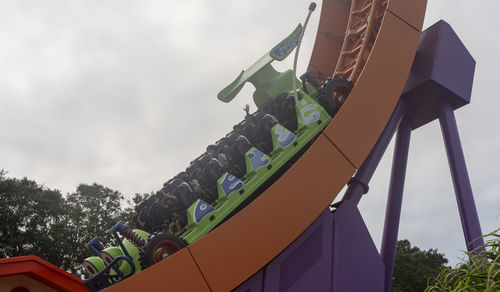 Low angle view of chain swing ride against sky