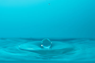Close-up of blue water drop in swimming pool