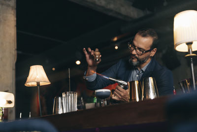 Male bartender preparing cocktail at bar counter