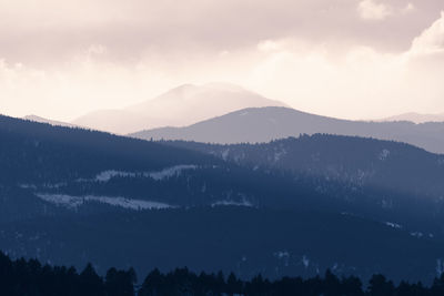 Scenic view of silhouette mountains against sky