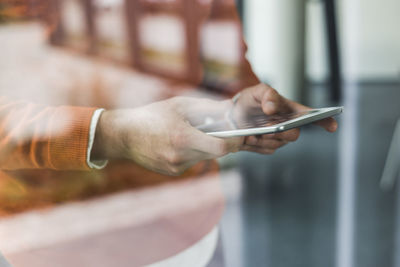 Close-up of man using phablet