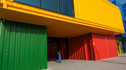 Rear view of man standing by building