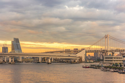 Sunset on circular highway leading to the rainbow bridge in odaiba bay of tokyo.