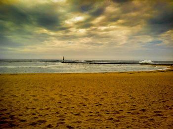 Scenic view of sea against cloudy sky