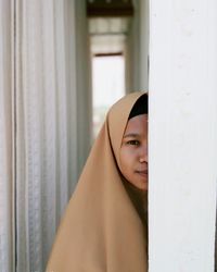 Portrait of young woman at home