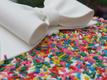 Close-up of cake with bow and sprinkles