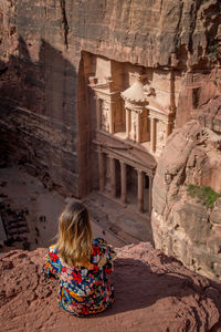 Rear view of woman standing on rock