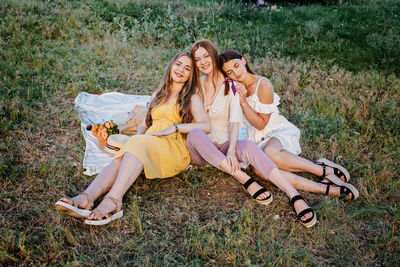 Summer party, outdoor gathering with friends. three young women, friends at the picnic having fun