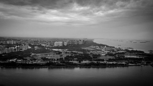 High angle view of buildings by sea against sky