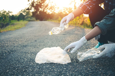 Low section of volunteers cleaning garbage from road