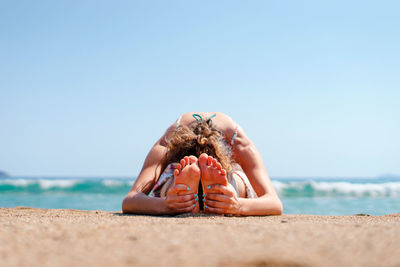 Man on beach against clear sky