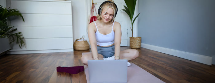 Portrait of young woman sitting on table