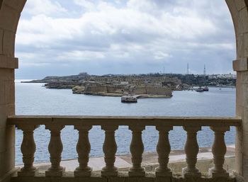 Boats in sea against buildings