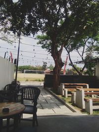 Empty chairs and table in park