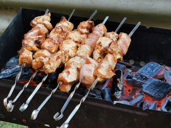 High angle view of meat on barbecue grill