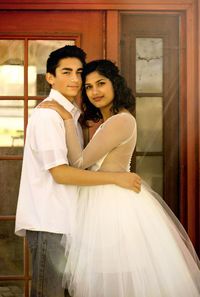 Side view portrait of couple standing against door