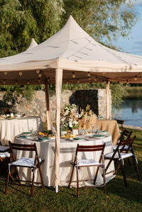 Empty chairs and tables in yard