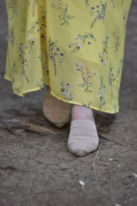 Stylish woman wearing summer shoes with straw sole outdoors.